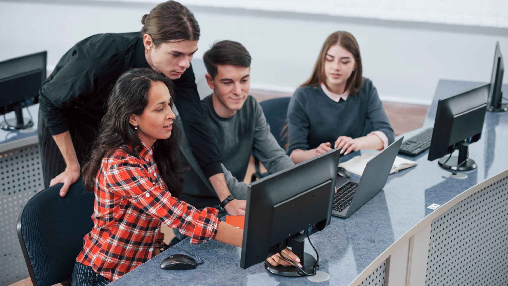 Look at this. Group of young people in casual clothes working in the modern office.